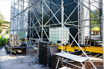 Backstage equipment and scaffolding for an outdoor event setup.