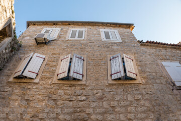 Medieval stone house with closed shutters