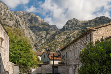 Kotor old town houses surrounding rock mountain and cloudy