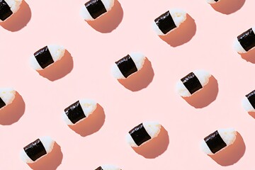 Motif de sushi nigiri sur un fond rose p&acirc;le, &eacute;voquant une ambiance culinaire japonaise..