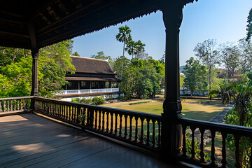 Beautiful traditional architecture in a lush garden setting, showcasing a serene view from the balcony