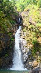 A waterfall in the middle of a forest in western Thailand