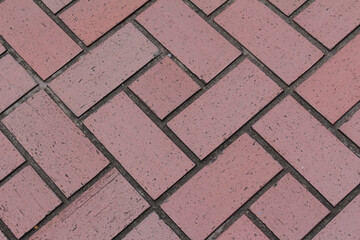 Red square paving tile. Brick pavement texture. Close up of concrete pavers background.