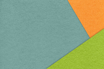 Texture of craft cyan color paper background with orange and green border. Vintage abstract blue cardboard.