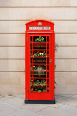 UK June 30 2024 A former public red telephone booth filled with plants in the City of Bath in Somerset, UK