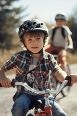 Obraz premium Two young boys enjoying a bicycle ride together. One child wearing a helmet for safety.