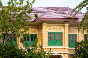 Yellow house with red roof, exterior architecture. Facade of typical European style of a house