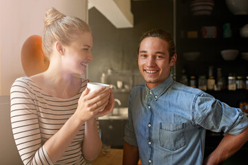 Couple, coffee or portrait with bonding in kitchen for connection, laughing or funny morning in home. People, happy or relax with caffeine in house for support, loyalty and commitment to relationship