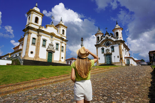 Tourism in Minas Gerais, Brazil. Back view of traveler girl visiting historical town of Mariana, Minas Gerais, Brazil.