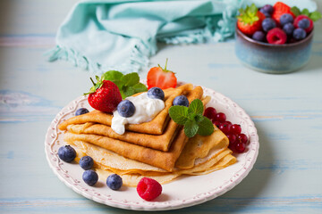 Crepes, thin pancakes  with yogurt and berries. Healthy food for breakfast