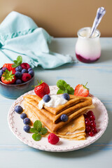 Crepes, thin pancakes  with yogurt and berries. Healthy food for breakfast