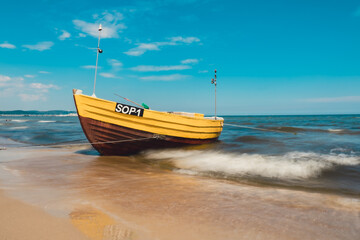 Fishing boat on the beach in Sopot, Poland. Magnificent long exposure calm Baltic Sea. Wallpaper...