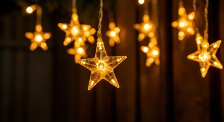 Star-shaped fairy lights emit a warm, inviting glow, hanging against a dark background, perfect for festive celebrations or cozy evenings