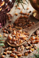 Myrrh resin on a spoon - ingredient for essential oils production