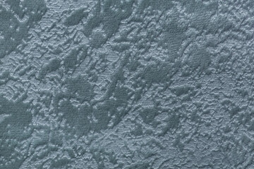 Texture of dark gray velvet background from soft upholstery textile, macro. Abstract grey velour fabric