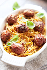 Spaghetti Pasta with Meatballs and fresh Basil on wooden background. Close up. 