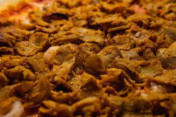 Close up photo of a delicious swedish pizza. Topped with kebab meat. 