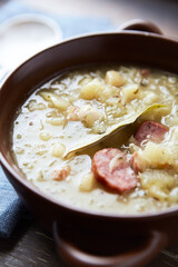 Cabbage soup on wooden background. Close up.