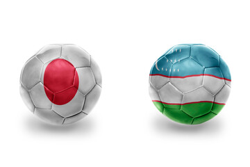 Fototapeta premium football balls with national flags of uzbekistan and japan ,soccer teams. on the white background.