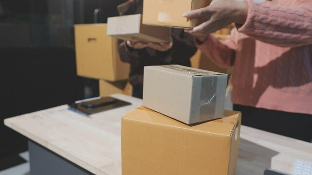 young start up small business owner packing cardboard box at workplace. freelance woman seller prepare parcel box of product for deliver to customer. Online selling, e-commerce, shipping concept