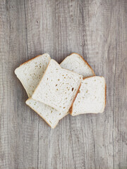 Square pieces of white toast bread on a wooden background