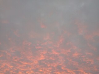 The pink sky with light background behind clouds