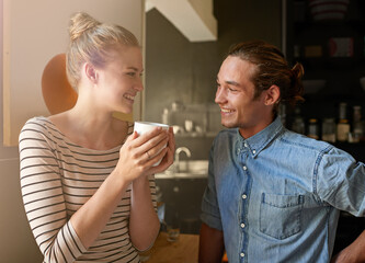 Couple, coffee and happy with bonding in kitchen for connection, laughing and funny morning in home. People, smile and relax with caffeine in house for support, loyalty and commitment to relationship