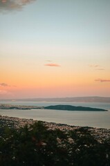 View from the top of the mountain with forest on the Adriatic sea at a beautiful bright sunset 