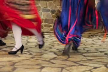 Cultural Dance Performance by Greek Women in Traditional Red and Blue Folk Dresses, Entertaining Guests at a Restaurant