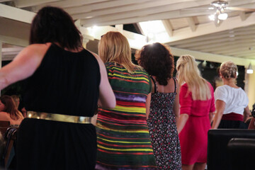 People Dancing at a Greek Restaurant on a Greek Island: Guests Join Performers for a Lively Cultural Celebration
