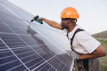 African American Engineer Inspecting Solar Panels on a Bright Sunny Day