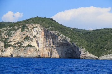 Scenic Greek Islands Landscape: Rock Formations, Cliffs, and Coastal Houses Viewed from the Sea