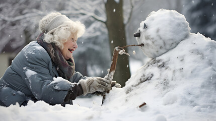 Senior Woman Building Snowman Winter Fun Outdoors