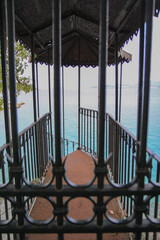 Rustic Metal Gazebo with Rusty Spiral Stairs Leading Toward the Sea, Surrounded by Greek Island Landscape