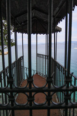 Rustic Metal Gazebo with Rusty Spiral Stairs Leading Toward the Sea, Surrounded by Greek Island Landscape