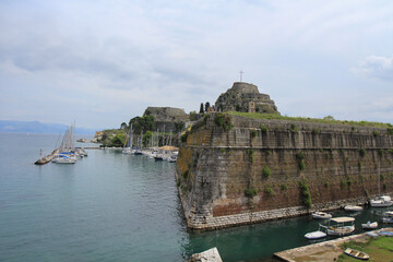 Fortress on the Sea Near a Greek Island: Historic Structure with a Cross on Top Overlooking the Ocean
