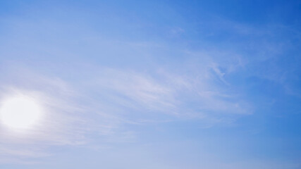 A  blue sky with a sun shining brightly