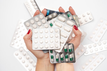 Pharmaceutical industry. Female hands holding  pharmaceuticals antibiotics pills medicine in...