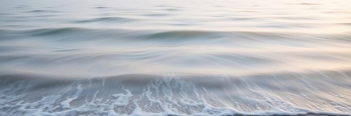 Fototapeta premium Softly undulating waves caress the shore as morning fog gently kisses the surface, gentle breeze, ocean wave