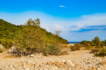 beautiful rocky landscape and beautiful blue sea at the end of the path and a road bridge between land and sea in Göynük Turkey (Antalya/Kemer)