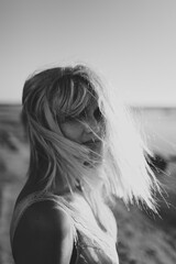 Blonde Woman Lost in Thought by the Ocean