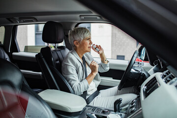 Senior businesswoman driving a car