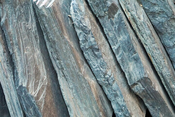 Close-up of rocks on the ground, arranged diagonally.