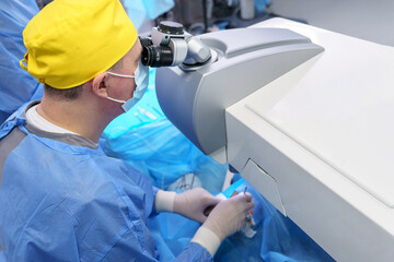 Ophthalmic Surgeon Using Microscope During Eye Surgery