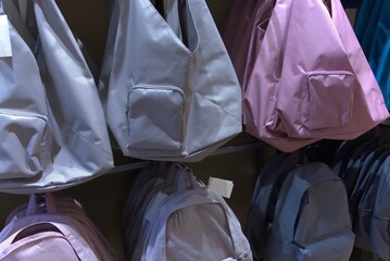 Several colored backpacks in a shop.