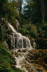 waterfall from mountain spring in dark place with moss in Krka national park in Croatia in summer