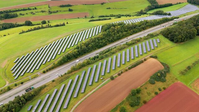 Solar panels alongside a highway in Germany. Aerial view.