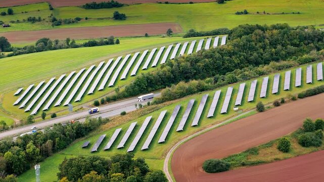Solar panels alongside a highway in Germany. Aerial view.