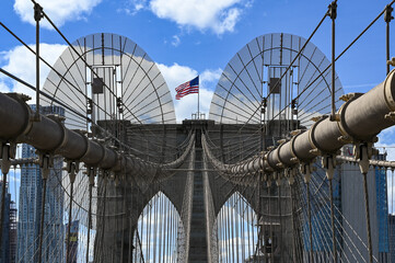 Brooklyn Bridge Symmetry with American Flag on a Bright Day