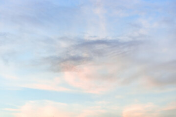 A beautiful sky tinted by the sun leaving vibrant shades of gold, pink, blue and multicolored. Clouds in the twilight evening and morning sky. Cloudy sky background in the evening, and during the day.